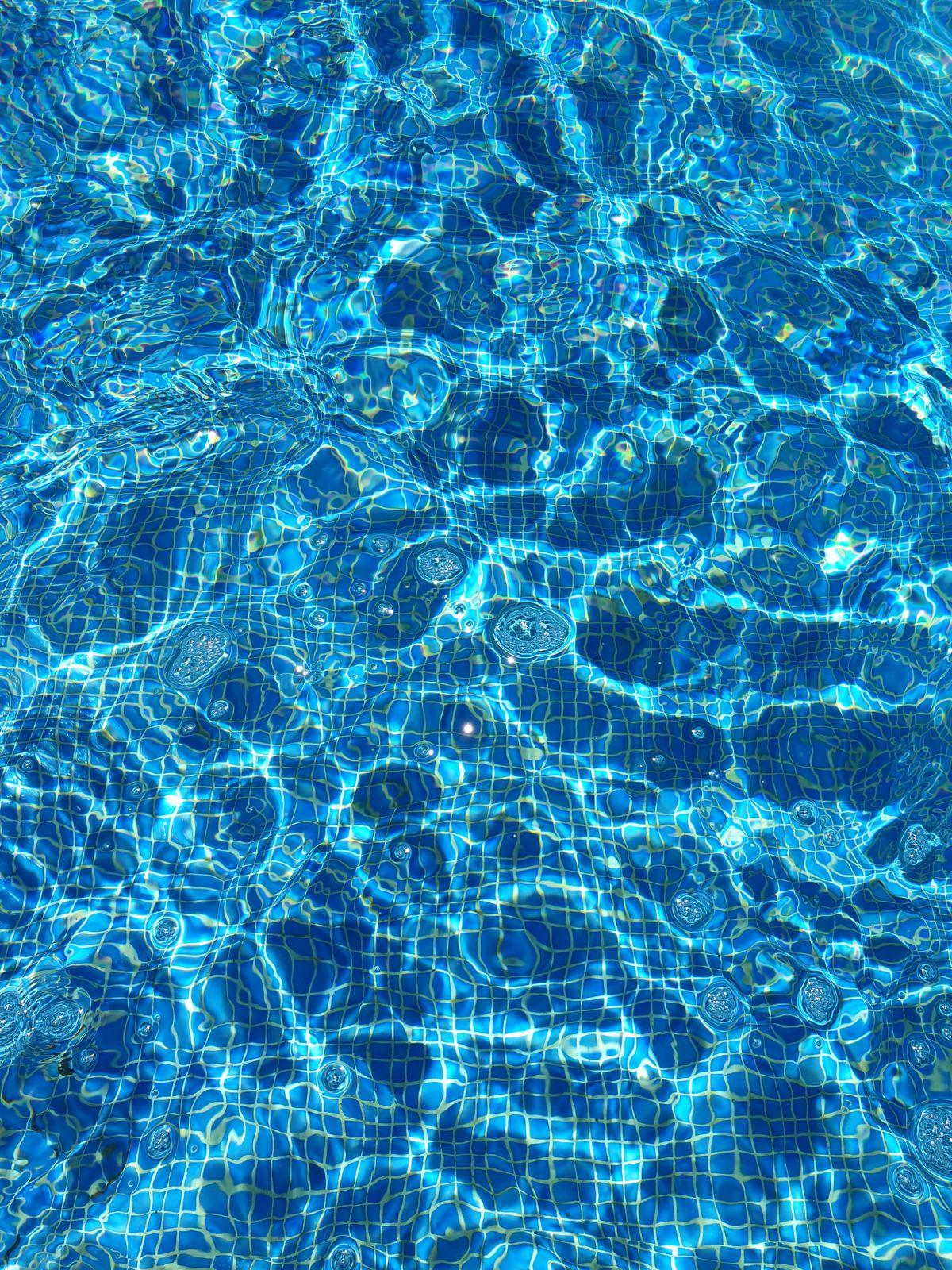 Sunlight sparkling on clear pool water